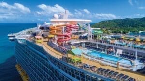Bliss Cruise Symphony of the Seas – November 2024 logo with boat and a slide